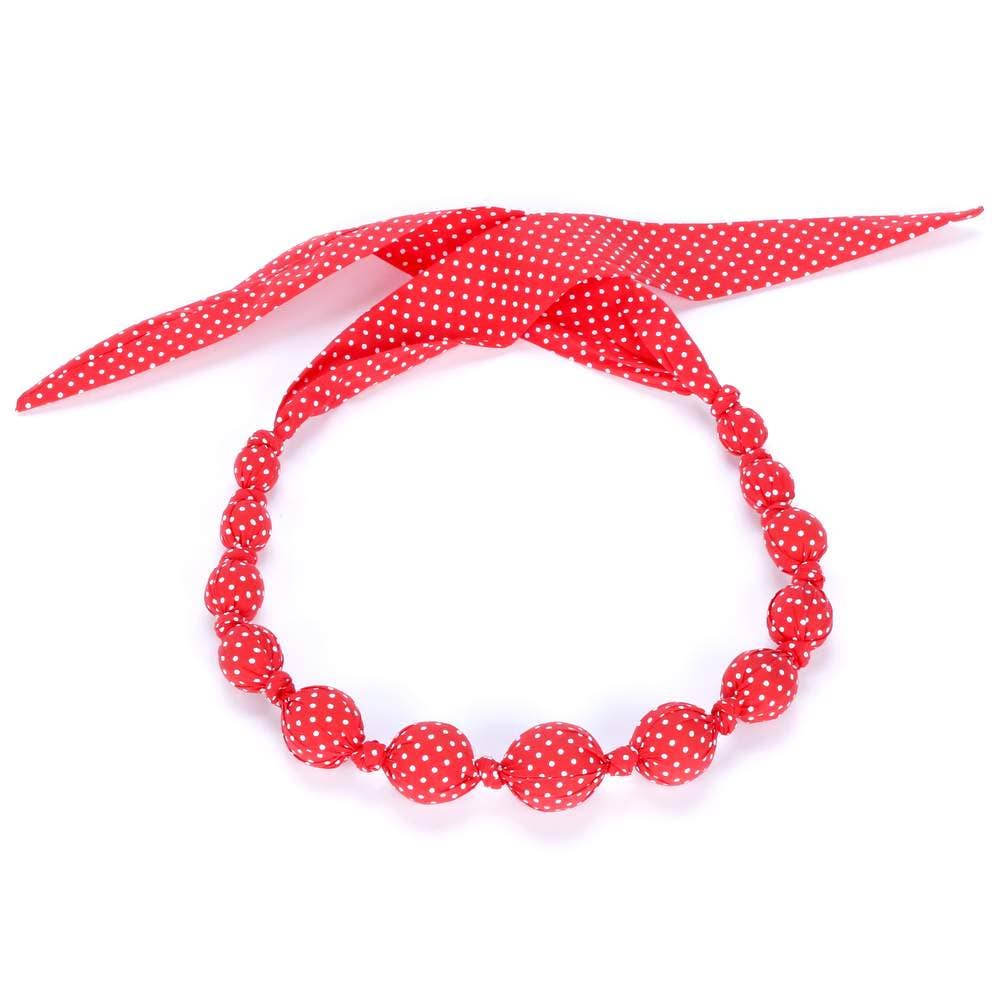 Red polka dot headband with a matching necklace on a white background
