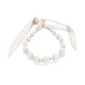 Set of pearl-like beaded bracelets on a white background