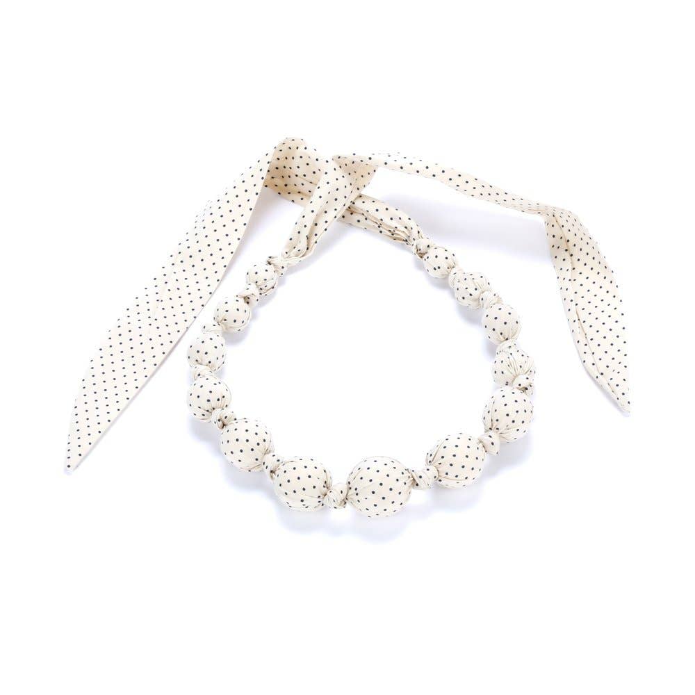 Set of pearl-like beaded bracelets on a white background