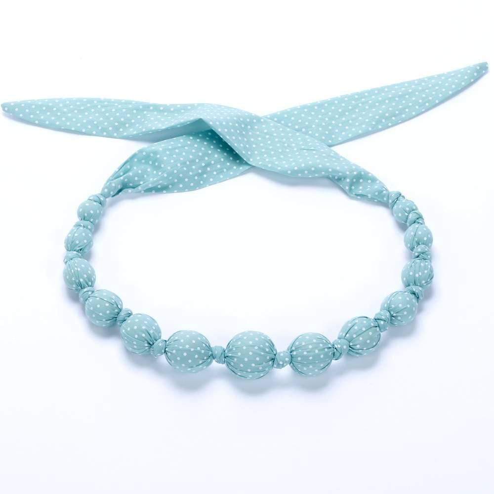 Light blue beaded headband with a matching bow on a white background